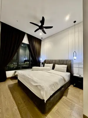 a bedroom with a large bed with a ceiling fan at Lucentia Residence Bukit Bintang LalaportBBCC By VELLORA in Kuala Lumpur