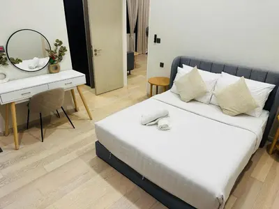 a bedroom with a bed and a desk with a mirror at Urban Starscape 50450, KL in Kuala Lumpur