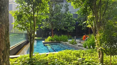a pool in the middle of a city with trees at Urban Starscape 50450, KL in Kuala Lumpur