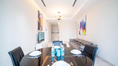 a dining room with a table and a couch at KLCC View Suites with balcony at The Manor Residence in Kuala Lumpur