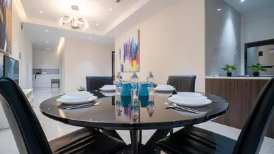 a dining room with a round table and chairs at KLCC View Suites with balcony at The Manor Residence in Kuala Lumpur