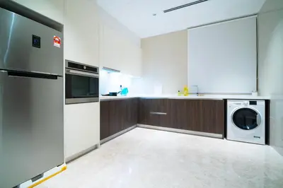 a kitchen with a washing machine and a washer and dryer at KLCC View Suites with balcony at The Manor Residence in Kuala Lumpur