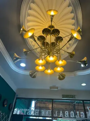 a chandelier hanging from the ceiling in a restaurant at KING HOSTEL by Global Inn in Kuala Lumpur