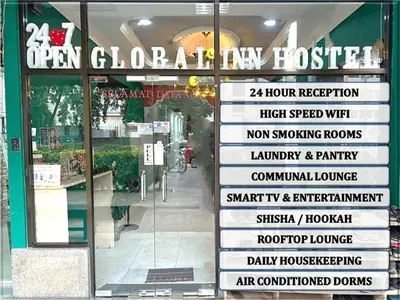 a store window with a sign in front of a store at KING HOSTEL by Global Inn in Kuala Lumpur