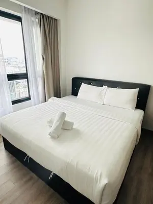 a large white bed with a white towel on it at Residence Agile Apartment at kulalampur in Kuala Lumpur