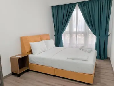 a bedroom with a bed and a window with green curtains at Residence Agile Apartment at kulalampur in Kuala Lumpur