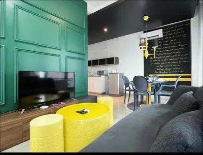 a living room with a couch and a tv and a table at Affordable at Arte Plus near KLCC with WiFi and Parking in Kuala Lumpur