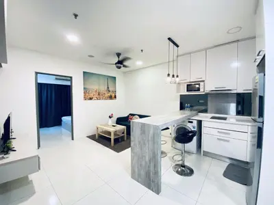 a kitchen with white cabinets and a counter top at Summer Suites KLCC by Vho'Z in Kuala Lumpur