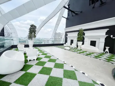 a room with a checkered floor and white chairs at Arte mont kiara by Paradigm Stay Free Parking in Kuala Lumpur