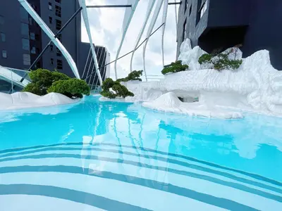 a large pool of water with an ice sculpture at Arte mont kiara by Paradigm Stay Free Parking in Kuala Lumpur