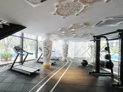 a gym with exercise equipment in a room with windows at Arte mont kiara by Paradigm Stay Free Parking in Kuala Lumpur
