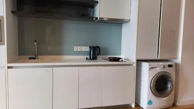 a kitchen with a sink and a washing machine at Aura Suites at Platinum KLCC in Kuala Lumpur