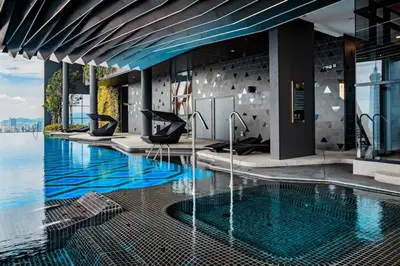 a swimming pool with a view of the water in a building at Scarletz Suites KLCC Rooftop Infinity Pool Near Twin Towers in Kuala Lumpur