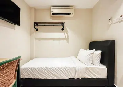 a small room with a bed and a tv at Swing & Pillows - Sentul Jalan Ipoh Kuala Lumpur in Kuala Lumpur