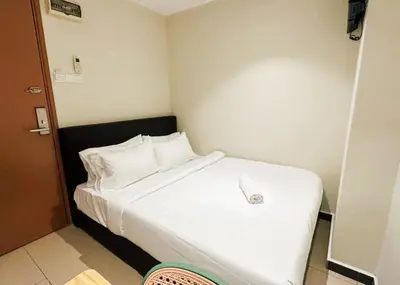 a bedroom with a white bed with a mouse on it at Swing & Pillows - Sentul Jalan Ipoh Kuala Lumpur in Kuala Lumpur