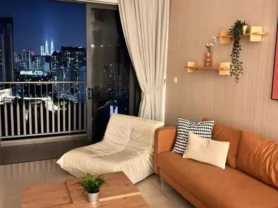 a living room with a couch and a window at Savio Residence in Kuala Lumpur
