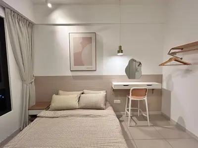 a small bedroom with a bed and a desk at Savio Residence in Kuala Lumpur