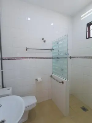 a bathroom with a toilet and a glass shower at Sentul KL Private Cozy Bungalow Homestay - Free Parking & Wifi in Kuala Lumpur