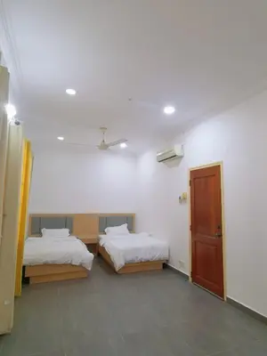 a room with two beds and a door in it at Sentul KL Private Cozy Bungalow Homestay - Free Parking & Wifi in Kuala Lumpur
