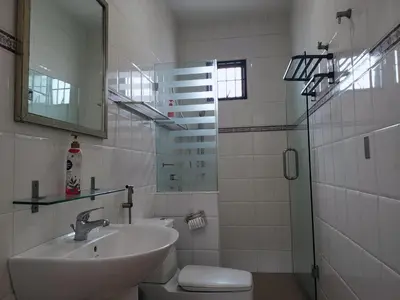 a bathroom with a sink and a toilet and a mirror at Sentul KL Private Cozy Bungalow Homestay - Free Parking & Wifi in Kuala Lumpur
