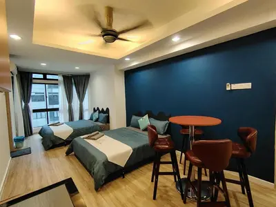 a bedroom with two beds and a table and a table at Fahrenheit88 Suites Bukit Bintang A 2R in Kuala Lumpur