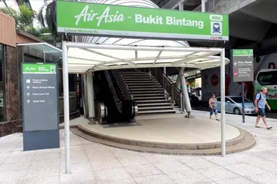 a bus stop with a sign in front of a building at Fahrenheit88 Suites Bukit Bintang A 2R in Kuala Lumpur