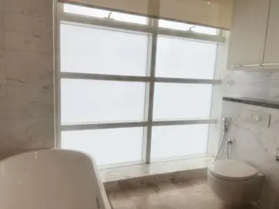 a bathroom with a toilet and a large window at PLATINUM SUITES KLCC By CHENLUN in Kuala Lumpur