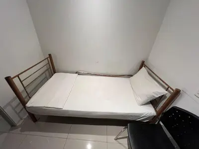 a small bed in a corner of a room at BG Travelers Home in Kuala Lumpur