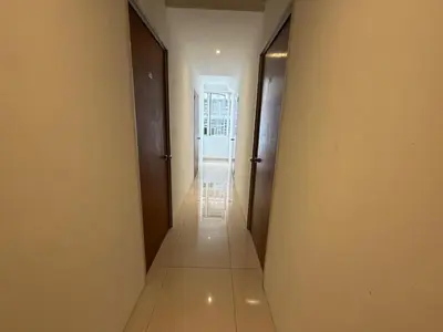a hallway with two doors and a long hallway with a corridorngthngthngthngth at BG Travelers Home in Kuala Lumpur