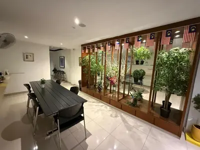 a room with a table and potted plants on a wall at BG Travelers Home in Kuala Lumpur