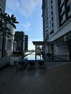 a building with a pool in the middle of a city at Rosewood Suites at Reizz Residence in Kuala Lumpur