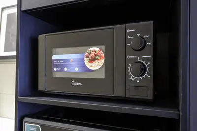 a microwave oven with a bowl of fruit on it at Majestic Residence KLCC Royal Premium King Bed in Kuala Lumpur