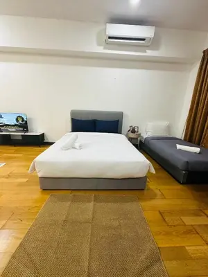a bedroom with a bed and a air conditioner at Regalia Apartments By FA 3 in Kuala Lumpur