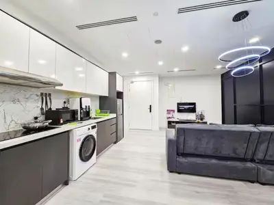 a large kitchen with a washer and dryer at Binjai 8 Modern Suites by CityNest in Kuala Lumpur