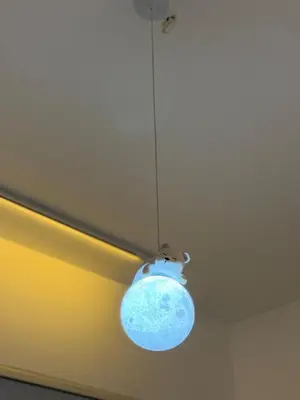 a blue light hanging from a ceiling at CherasCochrane walkto MRT Near TRX, KLCC, pavilion in Kuala Lumpur