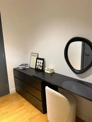 a black dresser with a mirror and a chair at CherasCochrane walkto MRT Near TRX, KLCC, pavilion in Kuala Lumpur