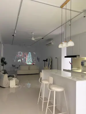 a living room with a counter and stools in it at CherasCochrane walkto MRT Near TRX, KLCC, pavilion in Kuala Lumpur
