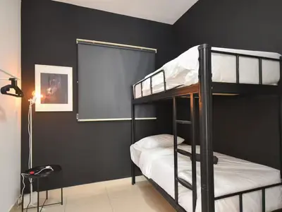 two bunk beds in a room with a black wall at Trion 2 KL Cityview Suites by CityNest in Kuala Lumpur