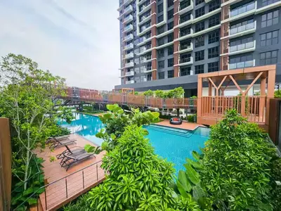 a swimming pool with a bridge and a building at Trion 2 KL Cityview Suites by CityNest in Kuala Lumpur