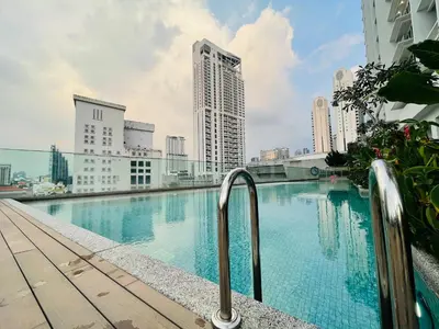 a swimming pool on the roof of a building with tall buildings at Quill KLCC By Signature in Kuala Lumpur