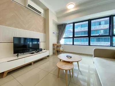 a living room with a tv and a couch and a table at Arte Plus Ampang Free Parking By Paradgm Stay in Batu Empat