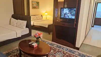 a living room with a tv and a couch and a table at BT Apartment times square kl in Kuala Lumpur
