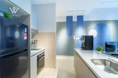 a kitchen with a sink and a refrigerator at 2BR Minimalist Urban Retreat at Trion KL in Kuala Lumpur
