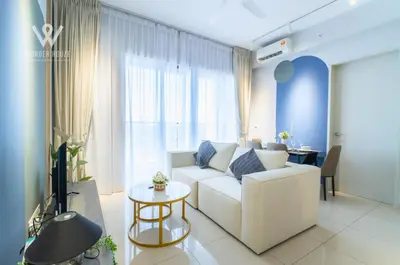 a living room with a white couch and a tv at 2BR Minimalist Urban Retreat at Trion KL in Kuala Lumpur
