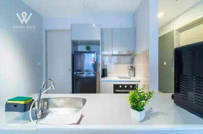 a kitchen with a sink and a refrigerator at 2BR Minimalist Urban Retreat at Trion KL in Kuala Lumpur