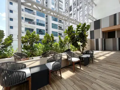 a patio with a table and chairs and a building at The Colony By Infinitum By Paradgm Stay in Kuala Lumpur