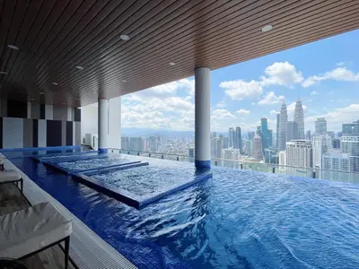 a swimming pool on top of a building with a city skyline at The Colony By Infinitum By Paradgm Stay in Kuala Lumpur