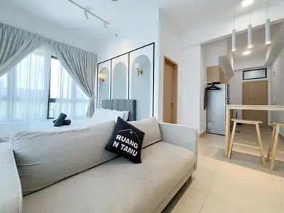 a bedroom with a bed and a couch at The Colony By Infinitum By Paradgm Stay in Kuala Lumpur
