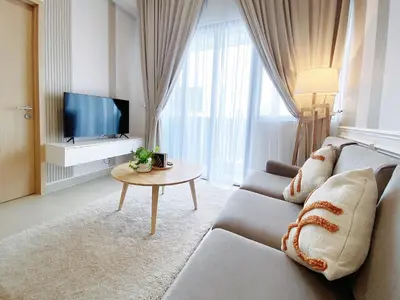 a living room with a couch and a tv at The Colony Infinitum By Paradgm Nest Stay in Kuala Lumpur