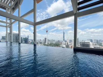 a infinity pool with a view of the city at The Colony Infinitum By Paradgm Nest Stay in Kuala Lumpur